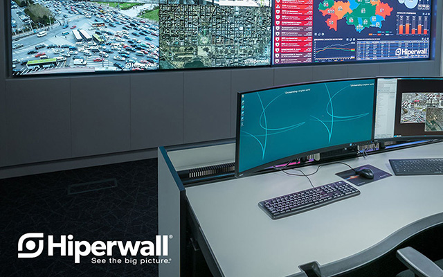 control room operator’s desk with monitor in front of a videowall