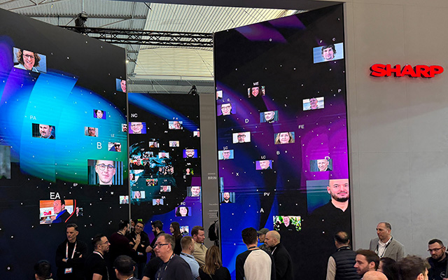 3 LED digital surfaces display images of people behind a crown of people